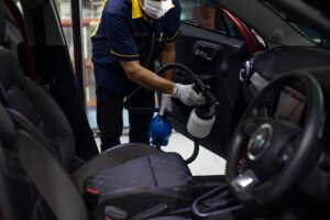 Man performing full valet with steam cleaner