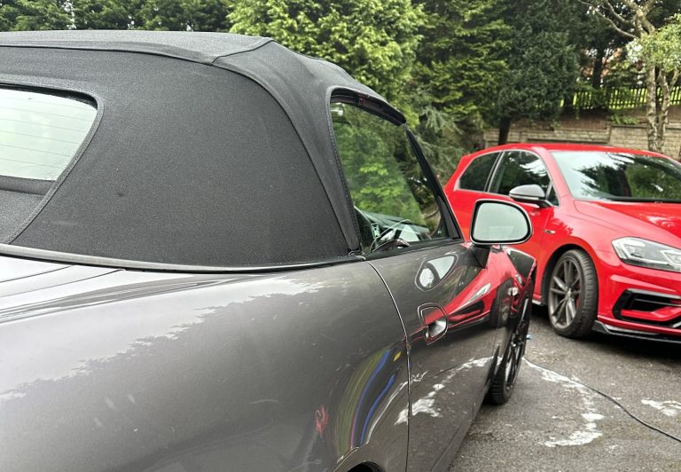 Picture showing 2 cars on a driveway, both are clean and positioned aesthetically